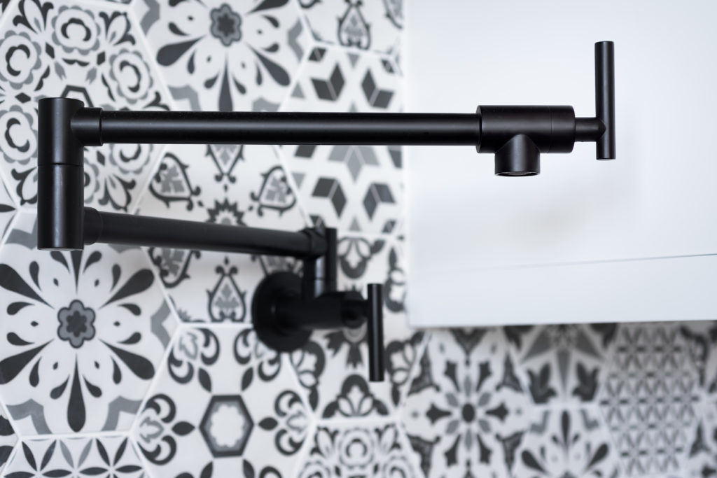 Matte black pot filler positioned over the stove.