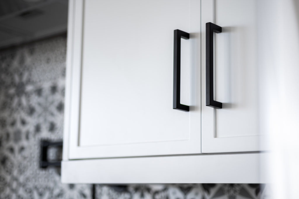 White cabinetry in a modern style kitchen.