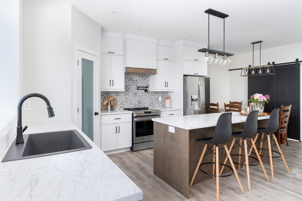 Modern style kitchen with a wood toned island.