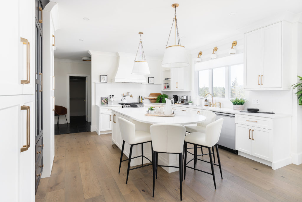 Transitional style kitchen with shaker doors and white quartz countertops.