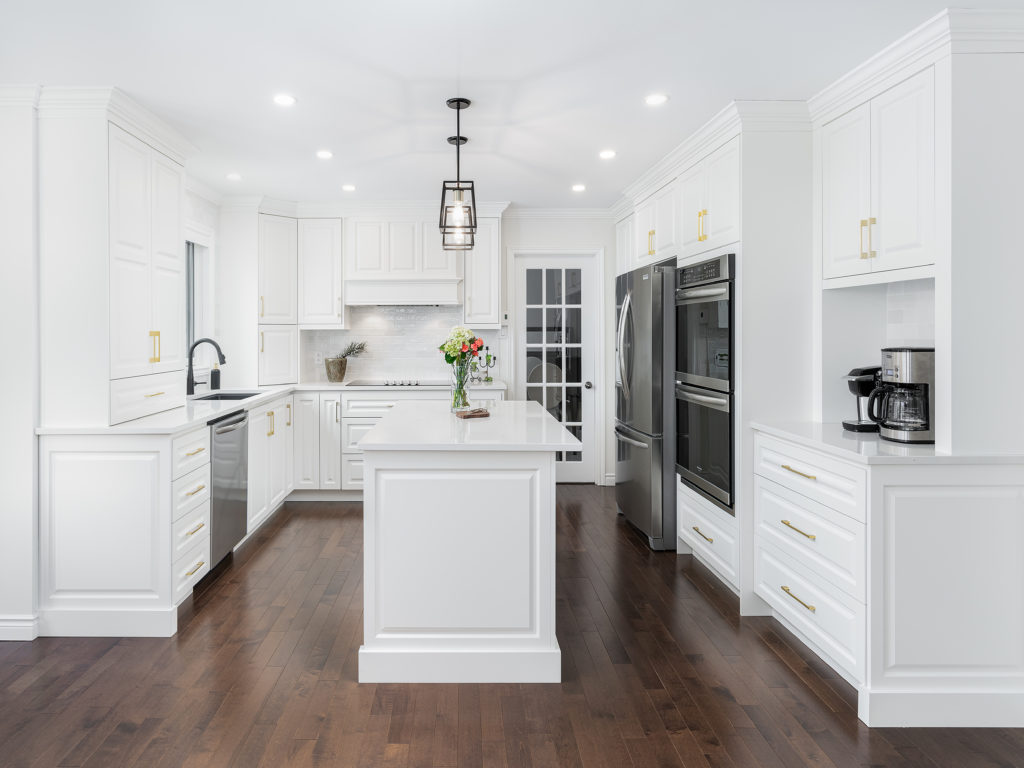 Traditional style kitchen with white cabinetry and gold hardware