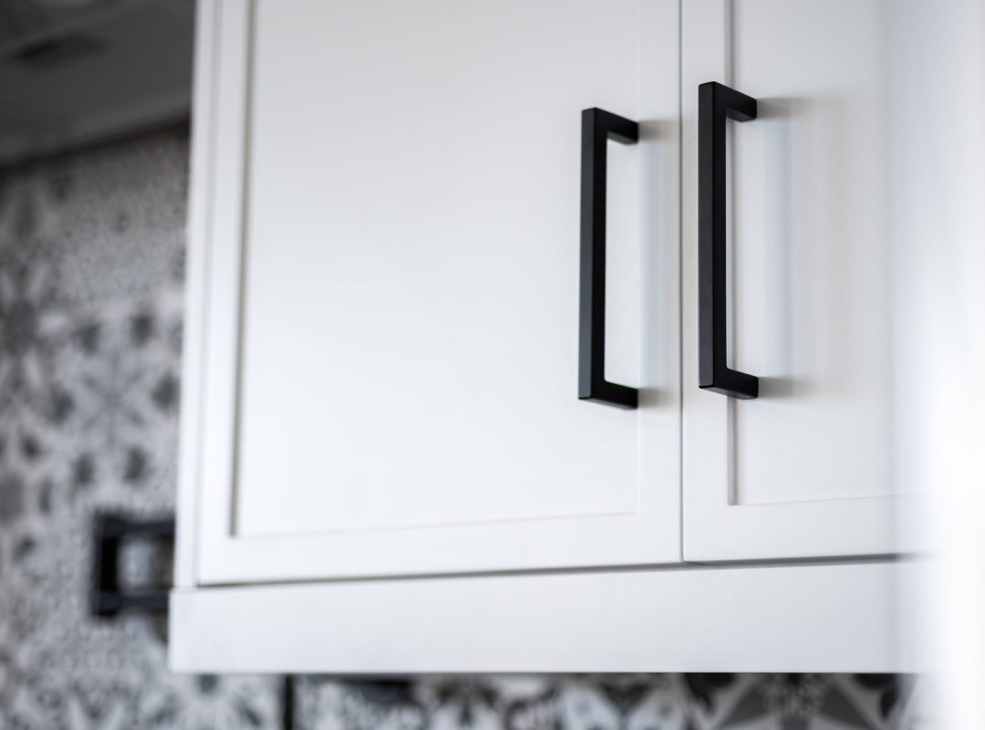White cabinetry in a modern style kitchen.